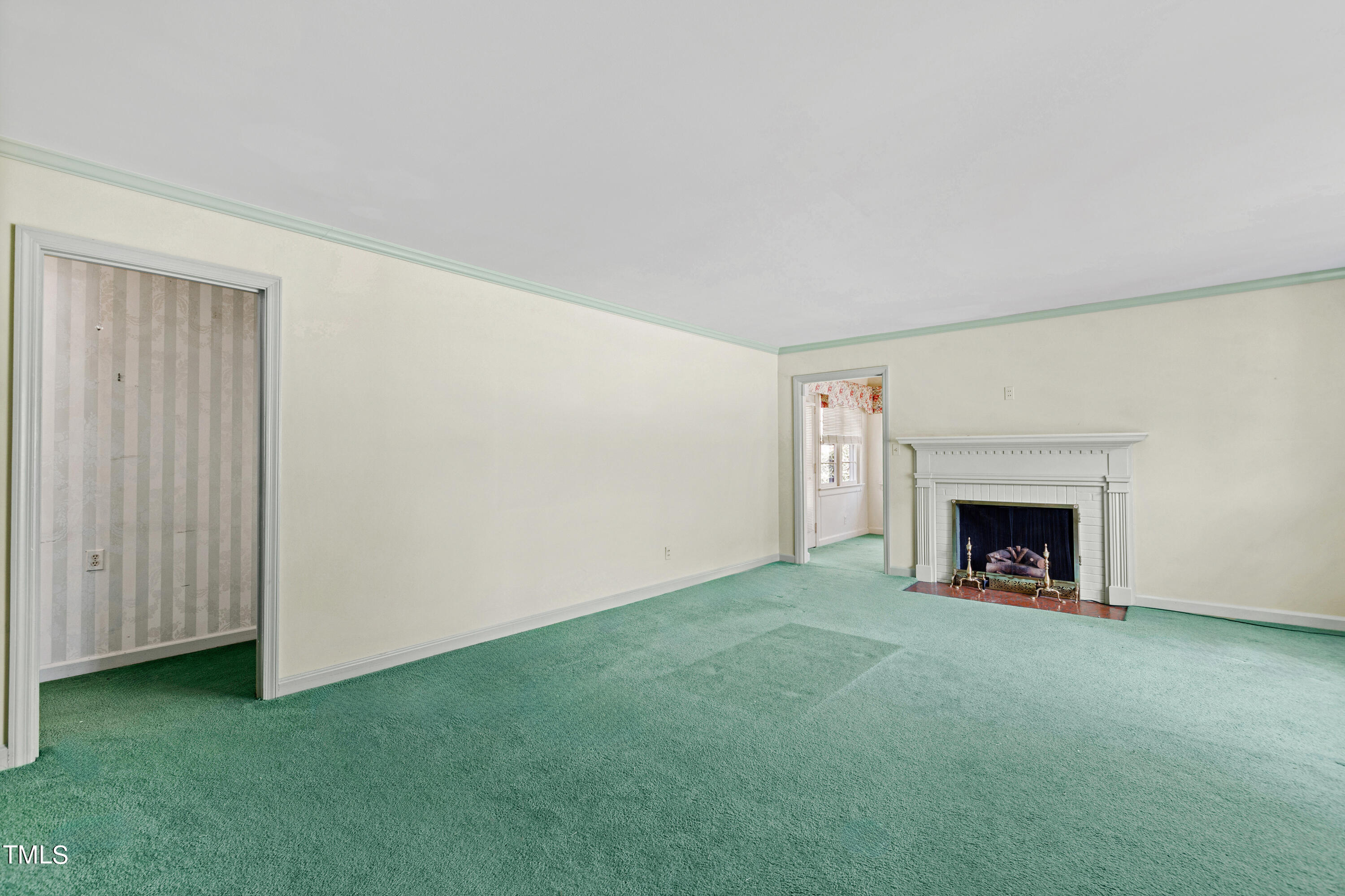 1725 Brooks Avenue Raleigh, NC 27607 - Photo 16 of 42 a view of an empty room with a fireplace and a window
