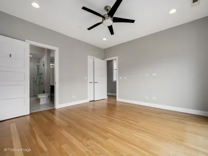 a view of an empty room and wooden floor