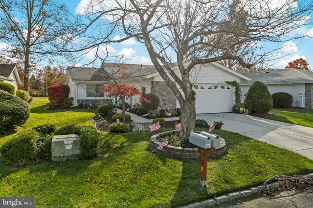a backyard of a house with fireplace table and chairs