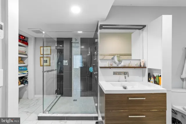 a bathroom with a shower sink and mirror