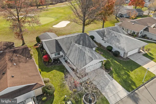 an aerial view of residential houses with outdoor space