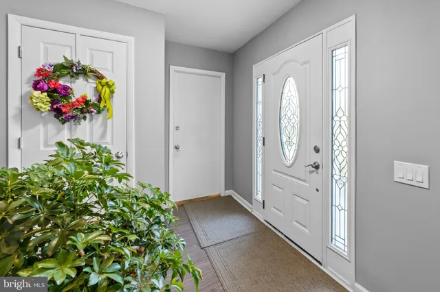 an entryway with flowers in front of it