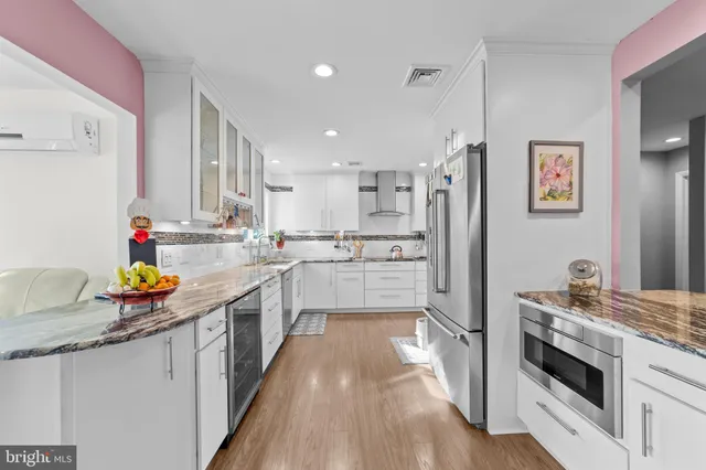 a kitchen with stainless steel appliances a stove a sink and a refrigerator