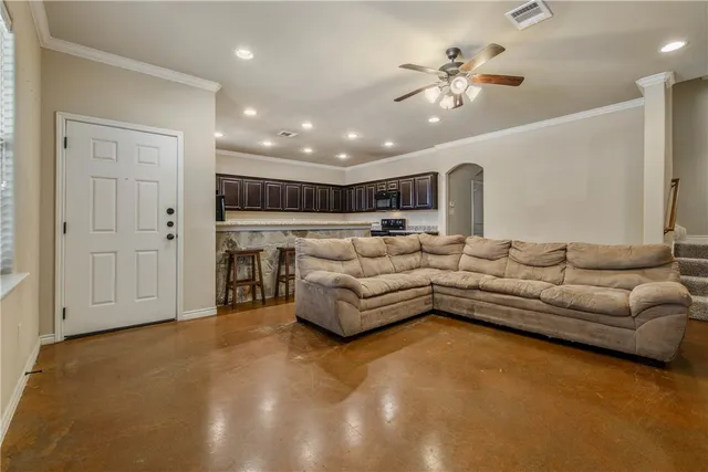 a living room with furniture and a chandelier