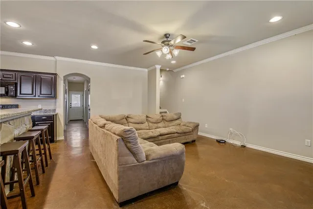 a living room with furniture and kitchen view
