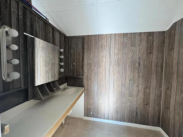 an empty room with closet and windows