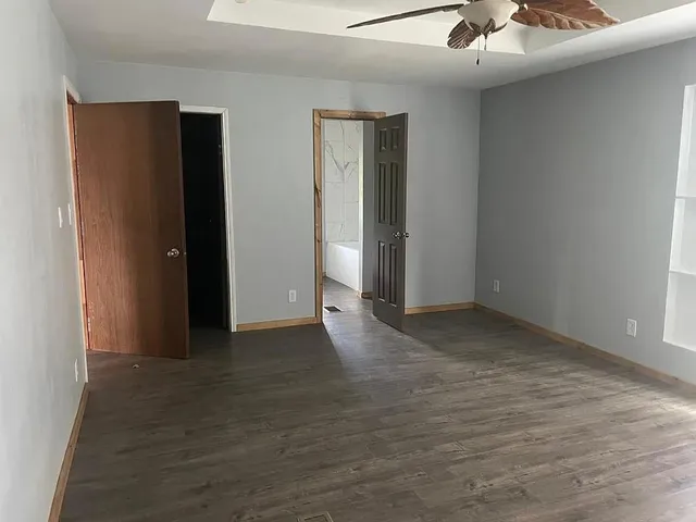a white toilet sitting next to a shower