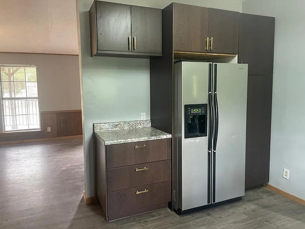 N/a N/a S Cr Road North Anna, TX 75409 - Photo 9 of 13 a view of a kitchen with a refrigerator and wooden floor