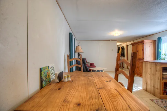 a bed room with a bed and a flat tv screen