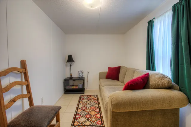 a living room with furniture and a mirror