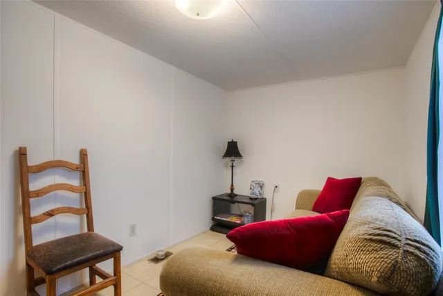 a living room with furniture and a chair