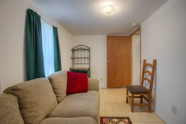a living room with furniture rug and a window