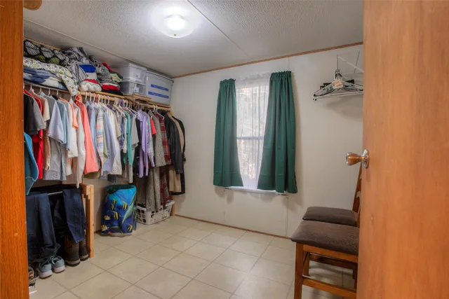 a view of walk in closet with clothes