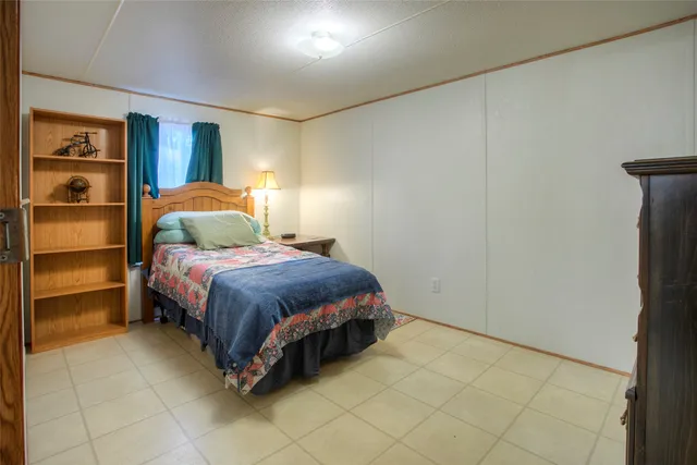 a bedroom with a bed and a lamp