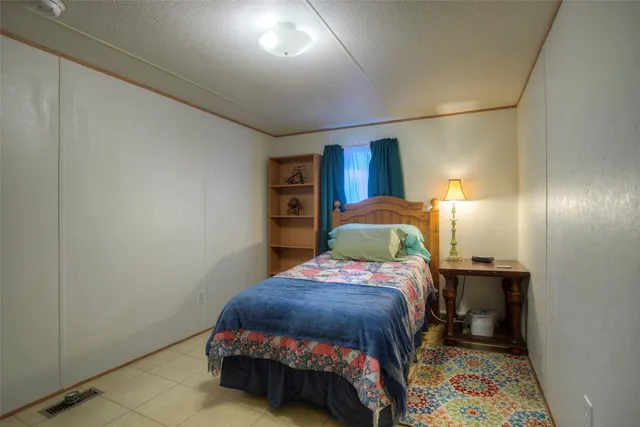 a bedroom with a bed and a dresser