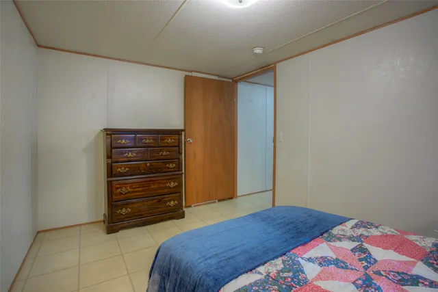 a bedroom with a bed and a dresser