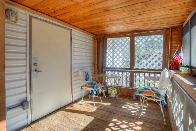 a view of a patio with a table and chairs