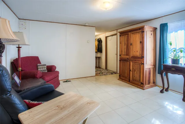 a living room with furniture a ceiling fan hardwood and a window