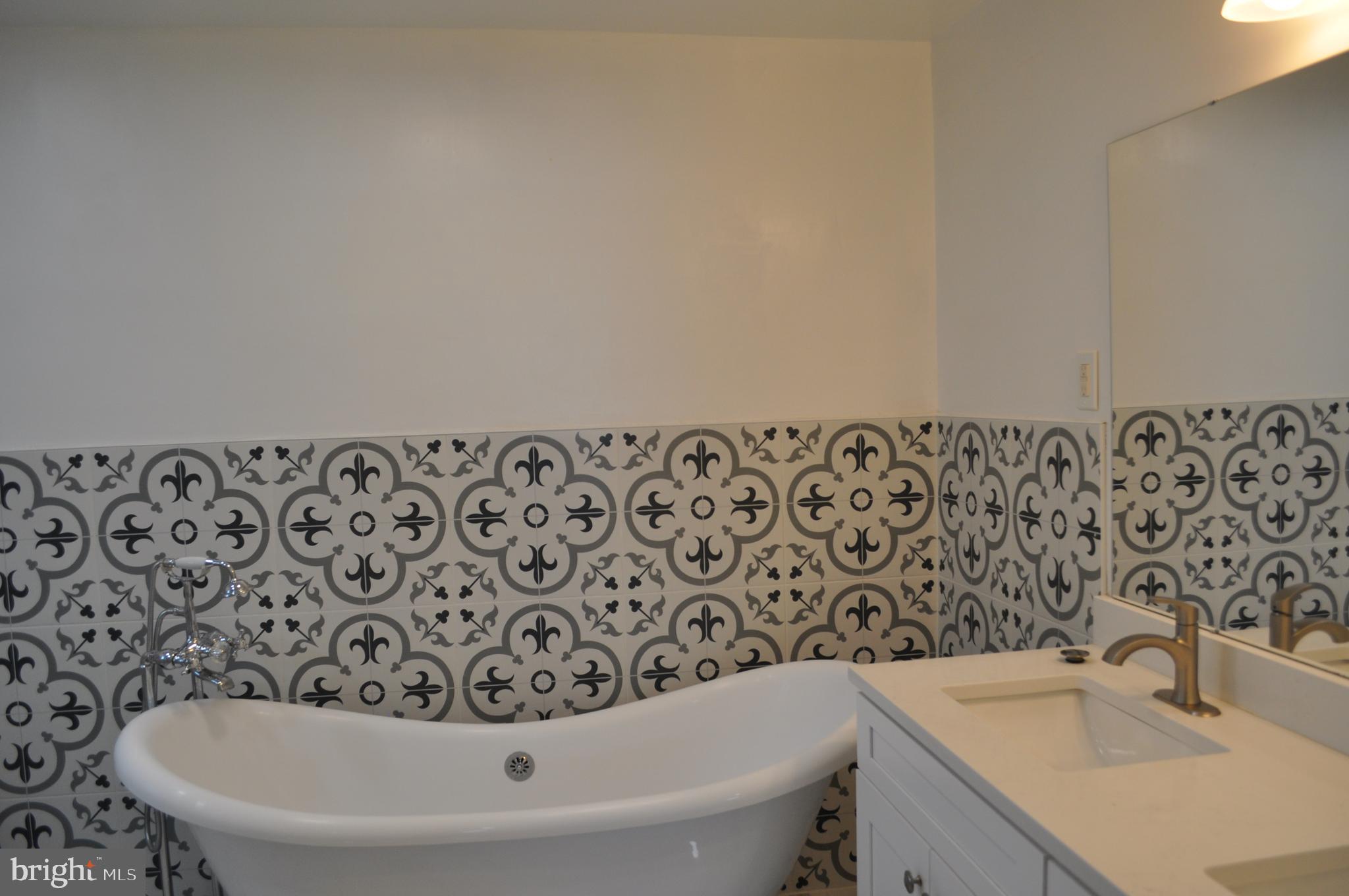 11809 Milbern Drive Potomac, MD 20854 - Photo 15 of 36 a bathroom with a bathtub and sink