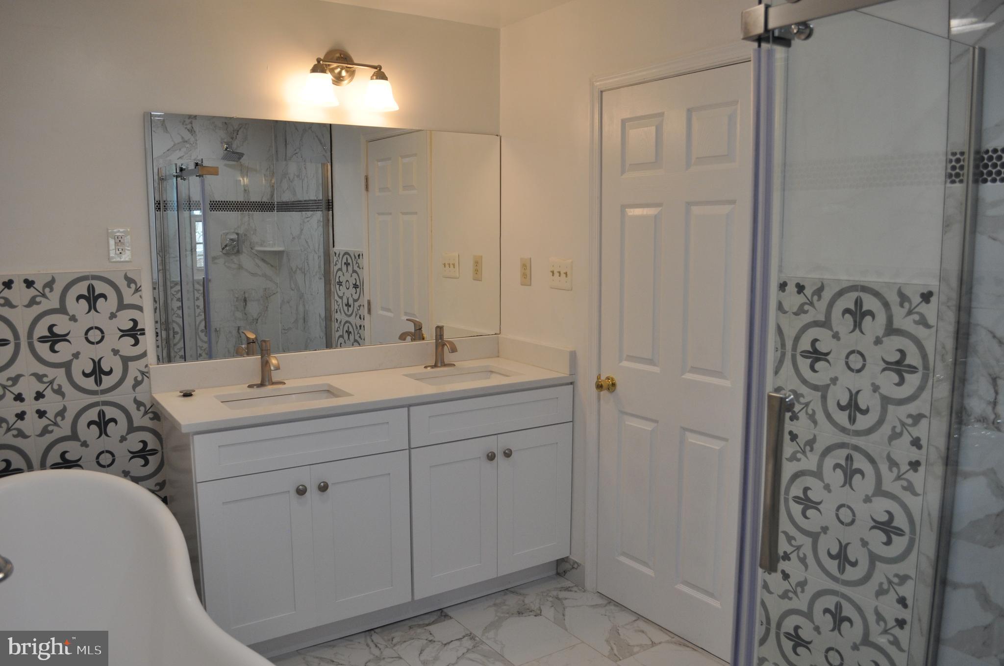 11809 Milbern Drive Potomac, MD 20854 - Photo 16 of 36 a bathroom with a double vanity sink mirror and shower