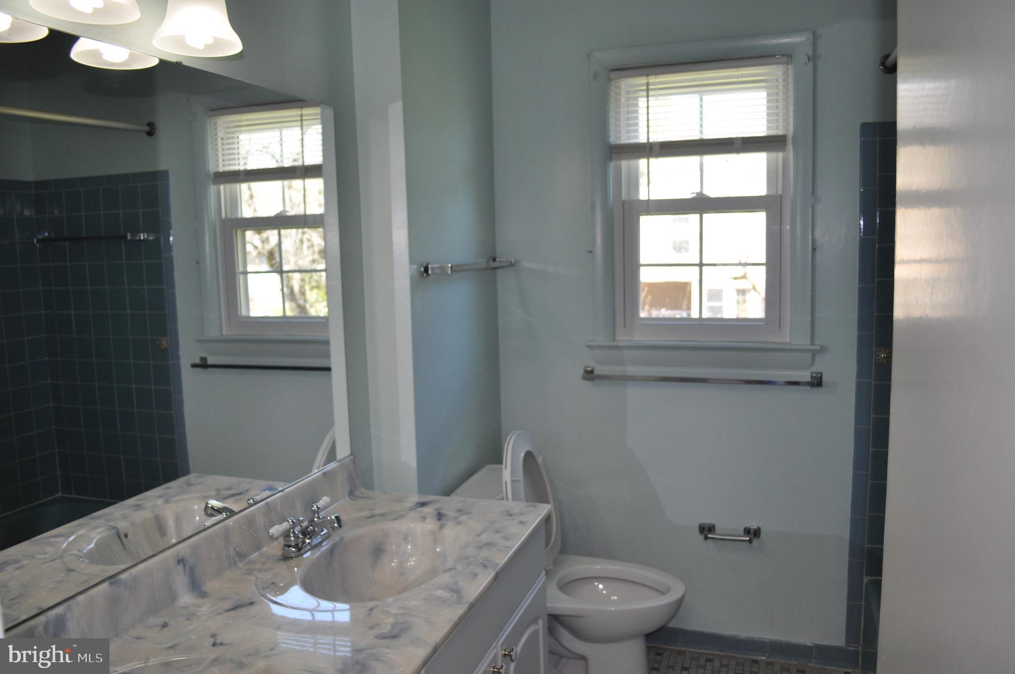 11809 Milbern Drive Potomac, MD 20854 - Photo 19 of 36 a bathroom with a granite countertop sink a toilet and a mirror