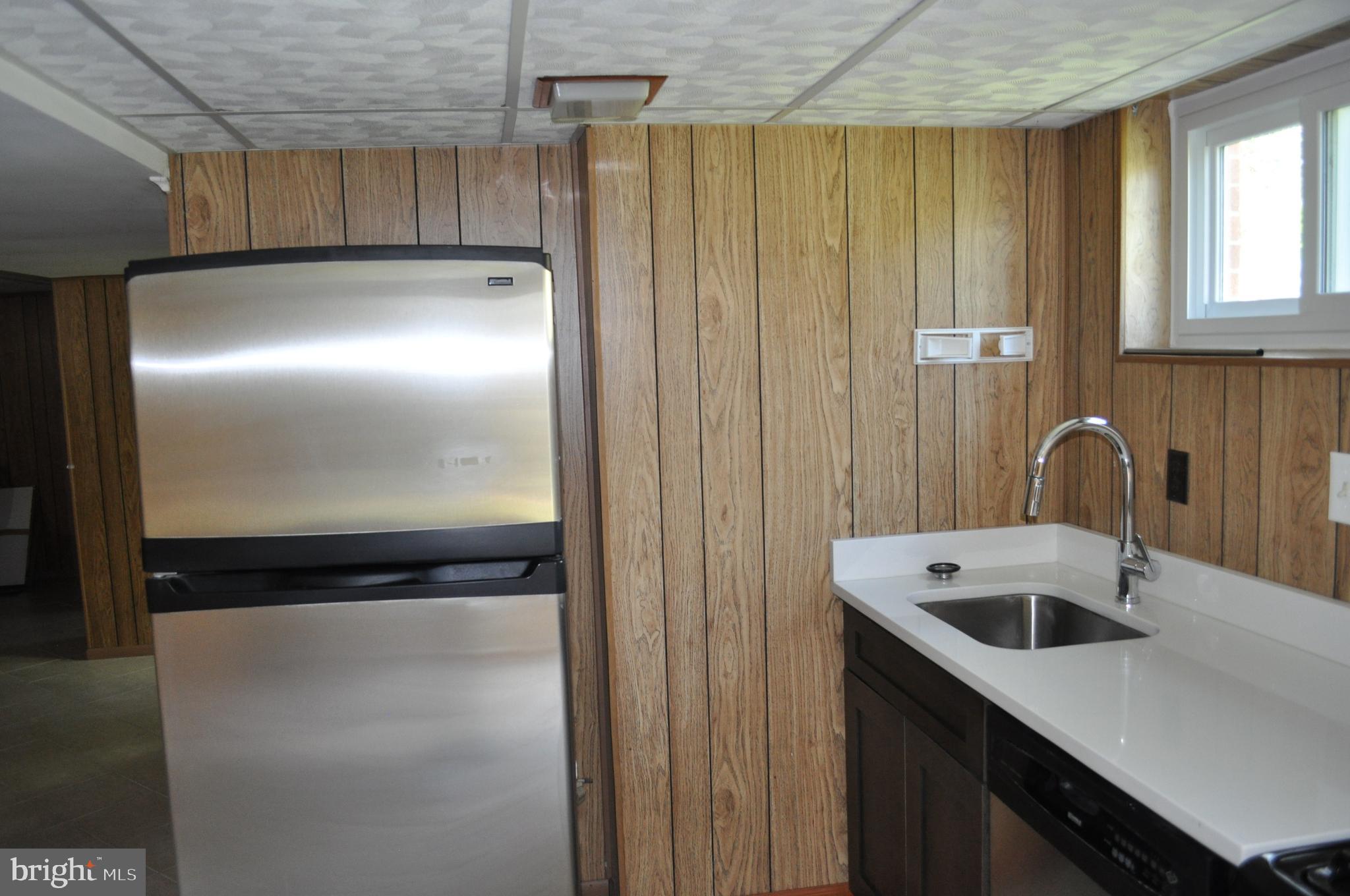 11809 Milbern Drive Potomac, MD 20854 - Photo 26 of 36 a kitchen with a refrigerator and a sink