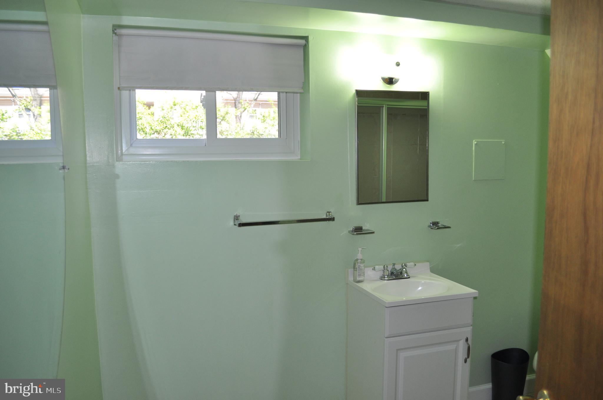 11809 Milbern Drive Potomac, MD 20854 - Photo 28 of 36 a bathroom with a sink and mirror