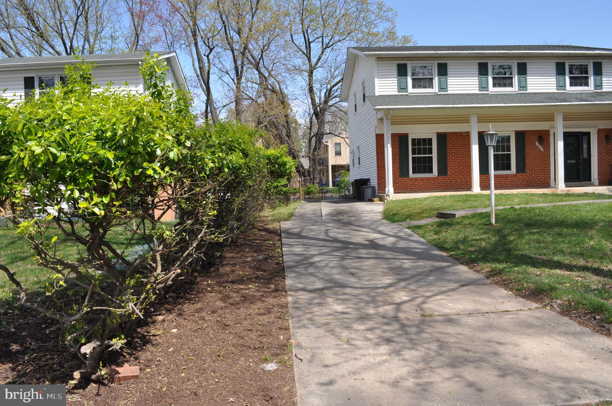 11809 Milbern Drive Potomac, MD 20854 - Photo 30 of 36 a pathway of a house with a yard