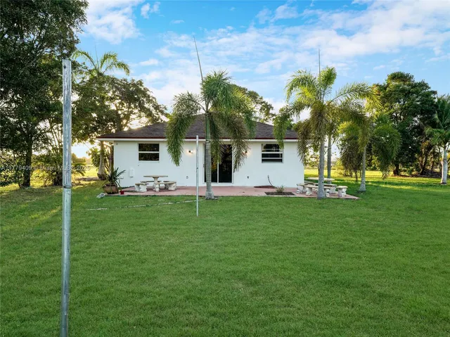 a front view of house with yard and outdoor seating