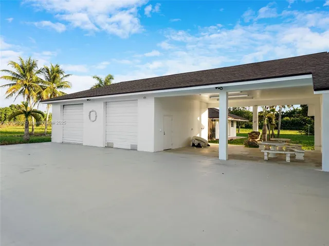 a view of a house with a patio and a garage
