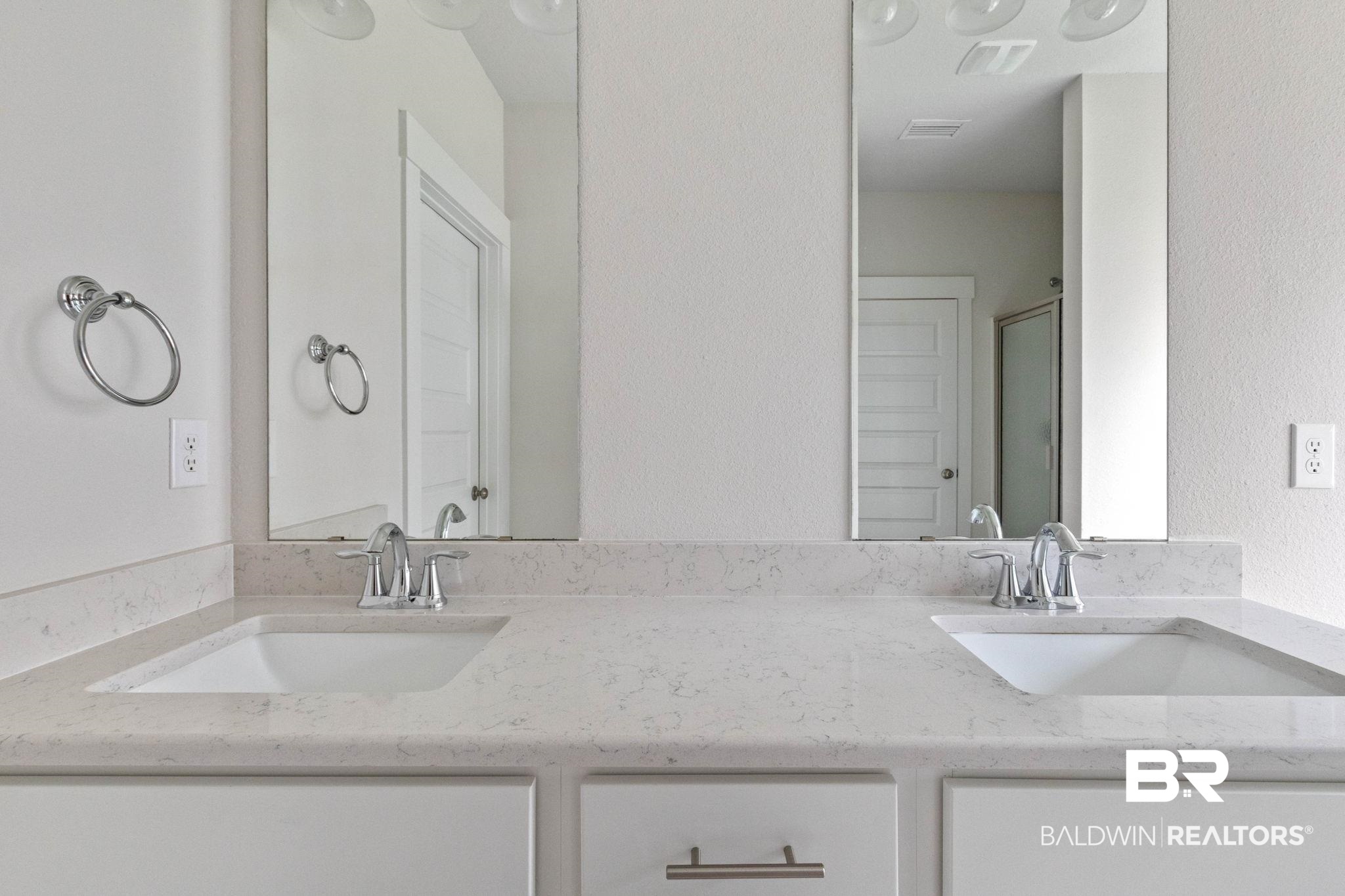 1710 Grouse Street Foley, AL 36535 - Photo 41 of 76 Contemporary bathroom vanity featuring dual undermount sinks, light-toned countertops, chrome fixtures, and integrated mirrors