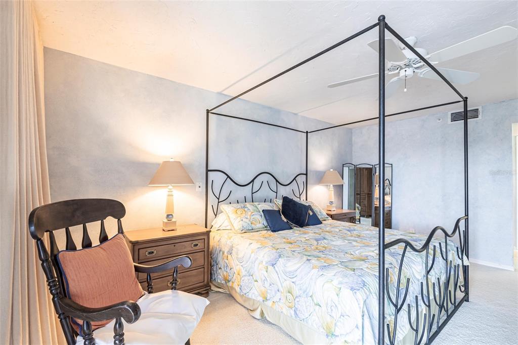 11000 Placida Road, Unit 1501 Placida, FL 33946 - Photo 18 of 46 a bedroom with a bed lamps and a walk in closet