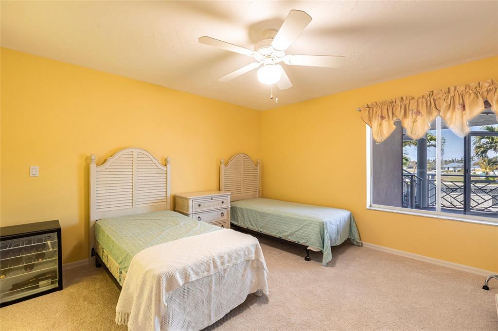 11000 Placida Road, Unit 1501 Placida, FL 33946 - Photo 25 of 46 a bedroom with a bed and a chandelier