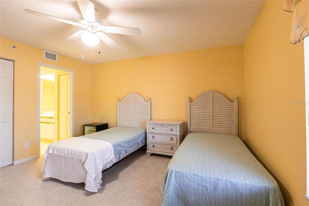 11000 Placida Road, Unit 1501 Placida, FL 33946 - Photo 26 of 46 a spacious bedroom with a bed and a chandelier