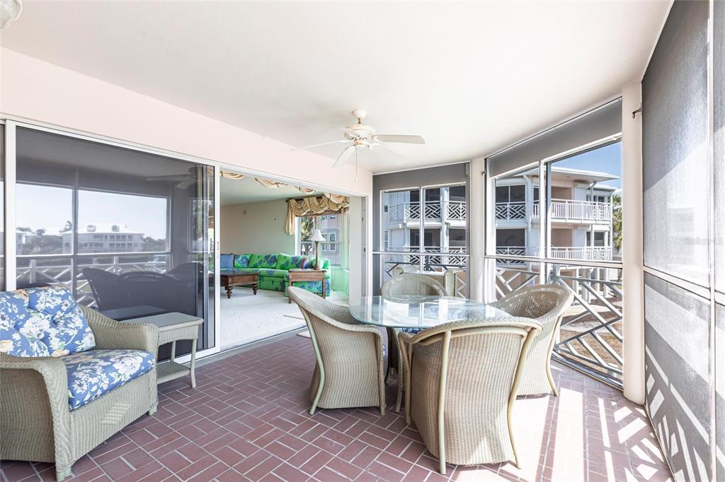 11000 Placida Road, Unit 1501 Placida, FL 33946 - Photo 33 of 46 a dining room with furniture and a floor to ceiling window