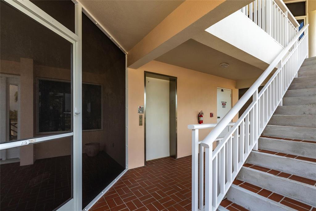 11000 Placida Road, Unit 1501 Placida, FL 33946 - Photo 39 of 46 a view of a hallway with wooden floor and staircase