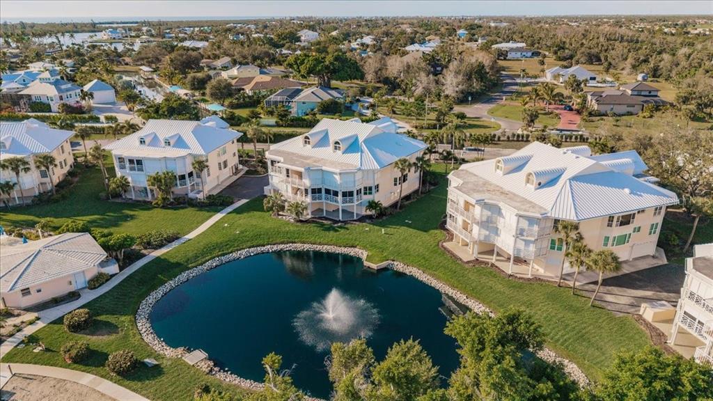 11000 Placida Road, Unit 1501 Placida, FL 33946 - Photo 43 of 46 an aerial view of a house with a garden and lake view