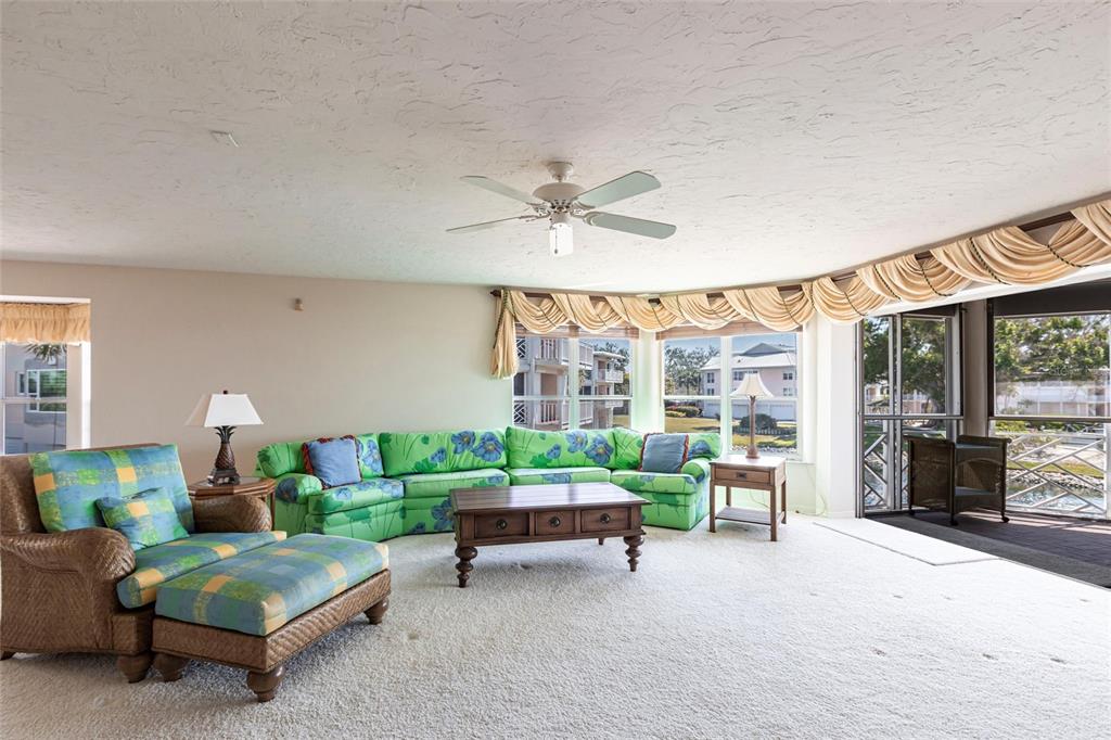 11000 Placida Road, Unit 1501 Placida, FL 33946 - Photo 8 of 46 a living room with furniture and a large window