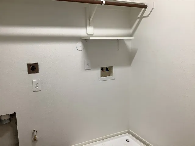 a view of a house with a small yard and wooden floor and fence