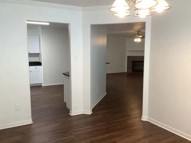 wooden floor in an empty room with a bathroom