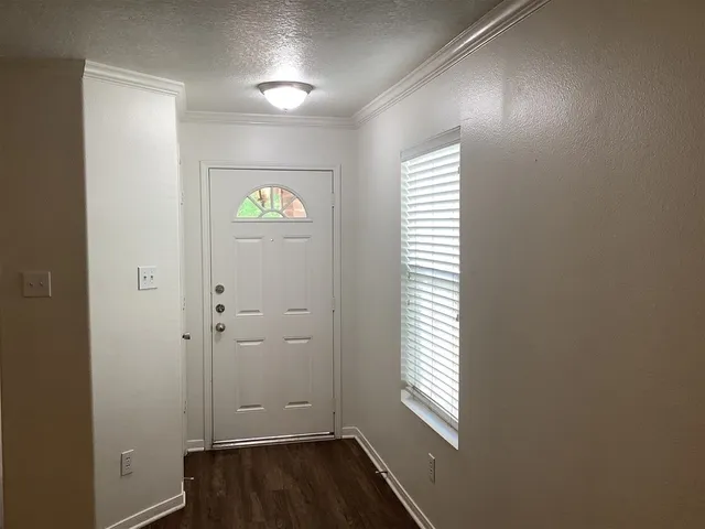 a view of an entryway with wooden floor