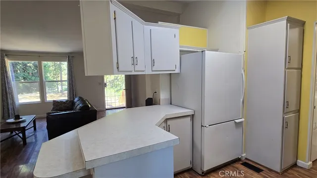 a bedroom with a bed and a refrigerator