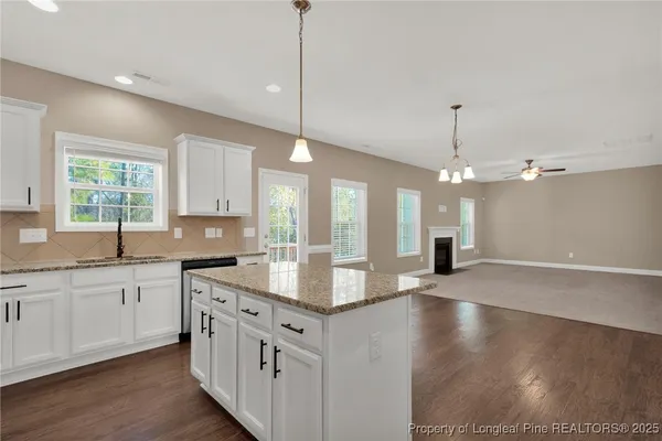 a kitchen with granite countertop a sink and a window