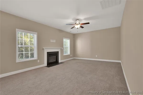 an empty room with wooden floor and window