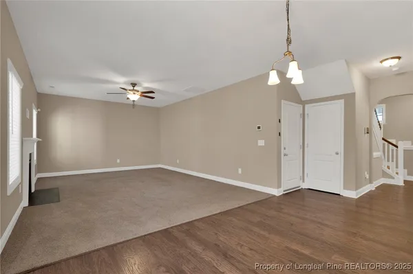 a kitchen with a dining table chairs refrigerator and cabinets