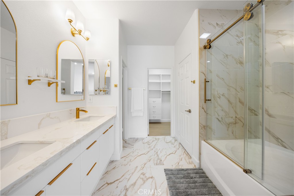 332 Quail Ridge Irvine, CA 92603 - Photo 14 of 25 a bathroom with a granite countertop sink a mirror a bathtub and shower