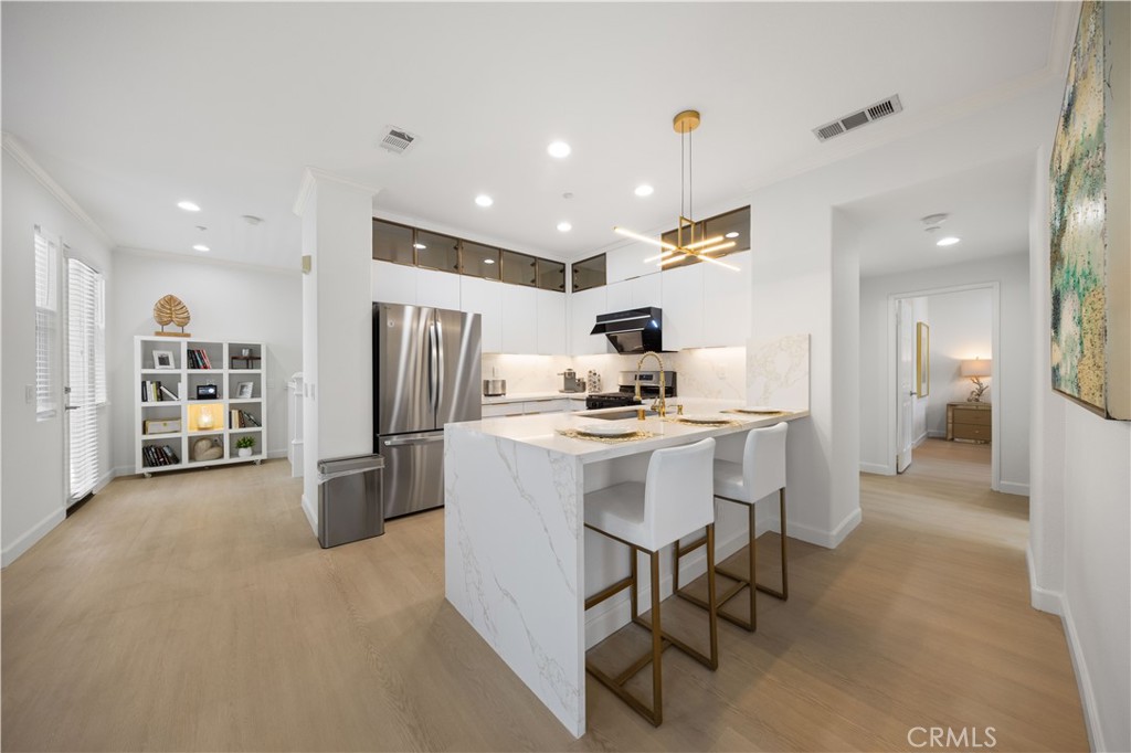 332 Quail Ridge Irvine, CA 92603 - Photo 6 of 25 a kitchen with refrigerator and chairs