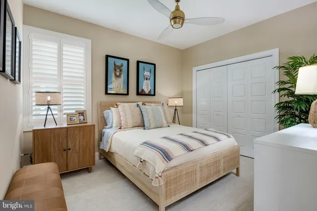 a spacious bedroom with a bed and a potted plant