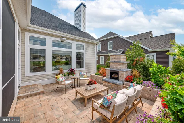 a outdoor space with patio the couches and a fireplace