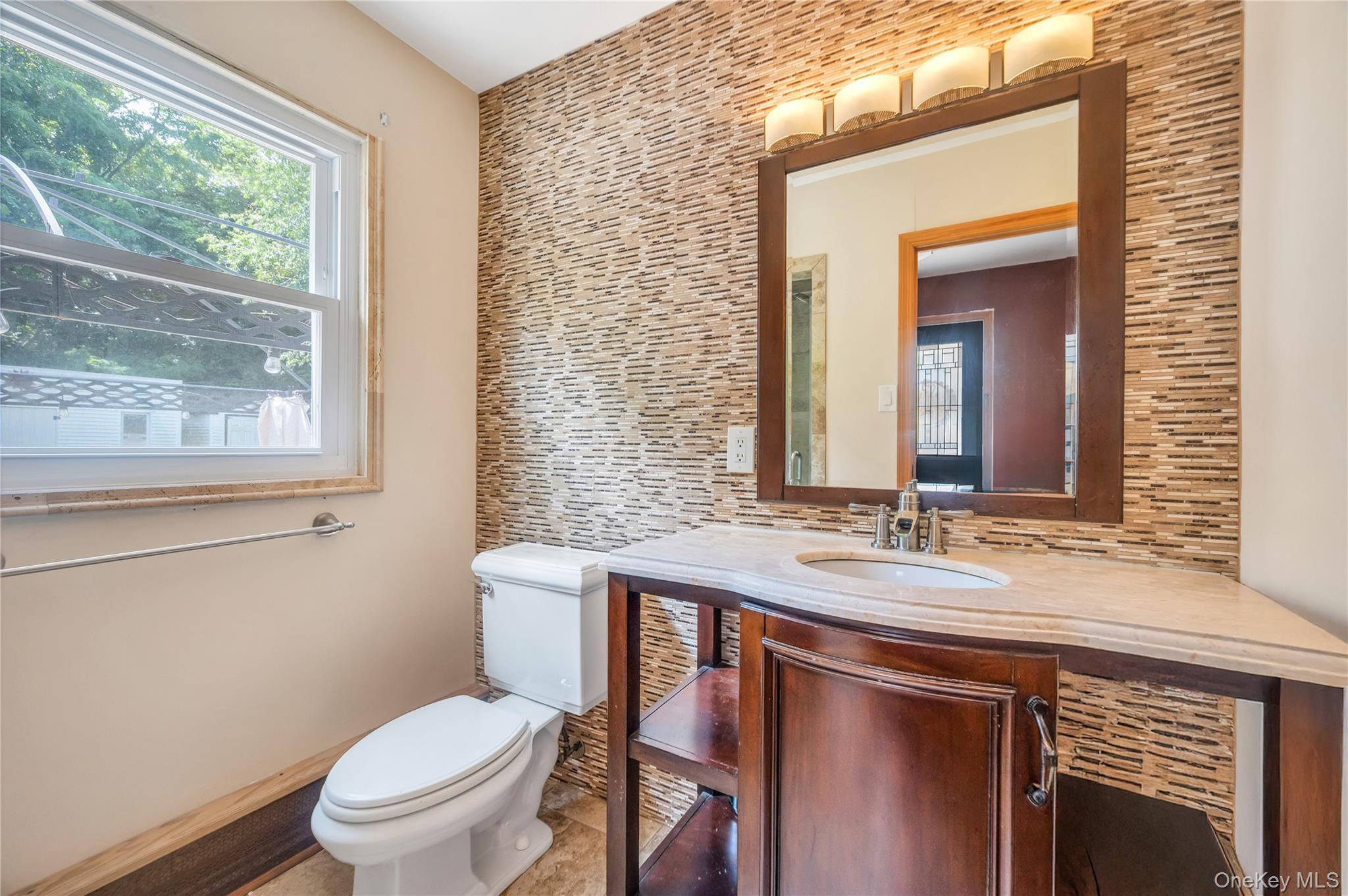 8 Brenner Road Coram, NY 11727 - Photo 12 of 18 Half bathroom featuring tasteful backsplash and vanity